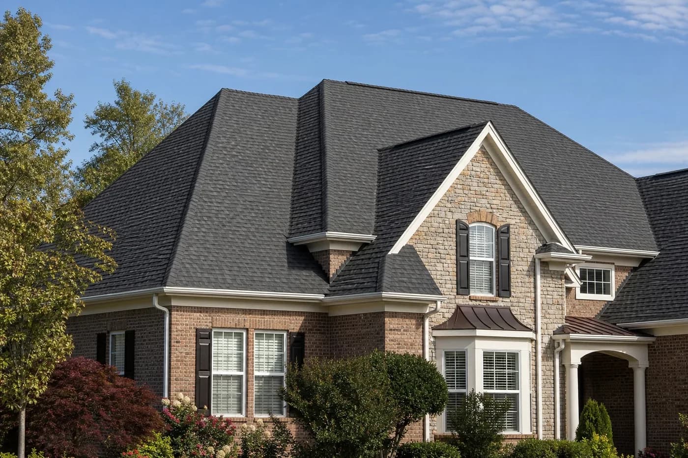 Roof-dominant upscale Indian Trail NC home with a clean charcoal architectural shingle roof