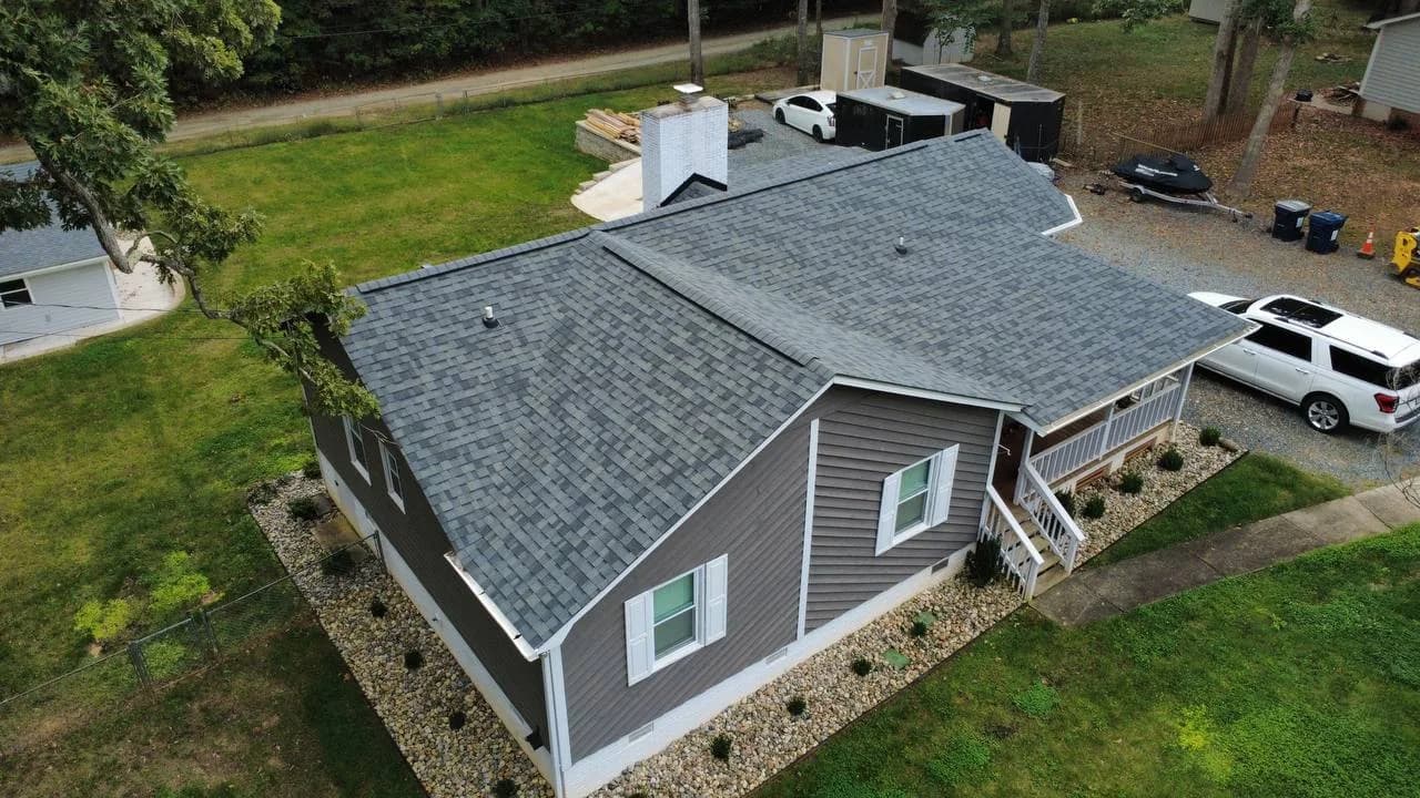 Drone photo of architectural shingle roof replacement on a gray ranch home by Kaliber Roofing