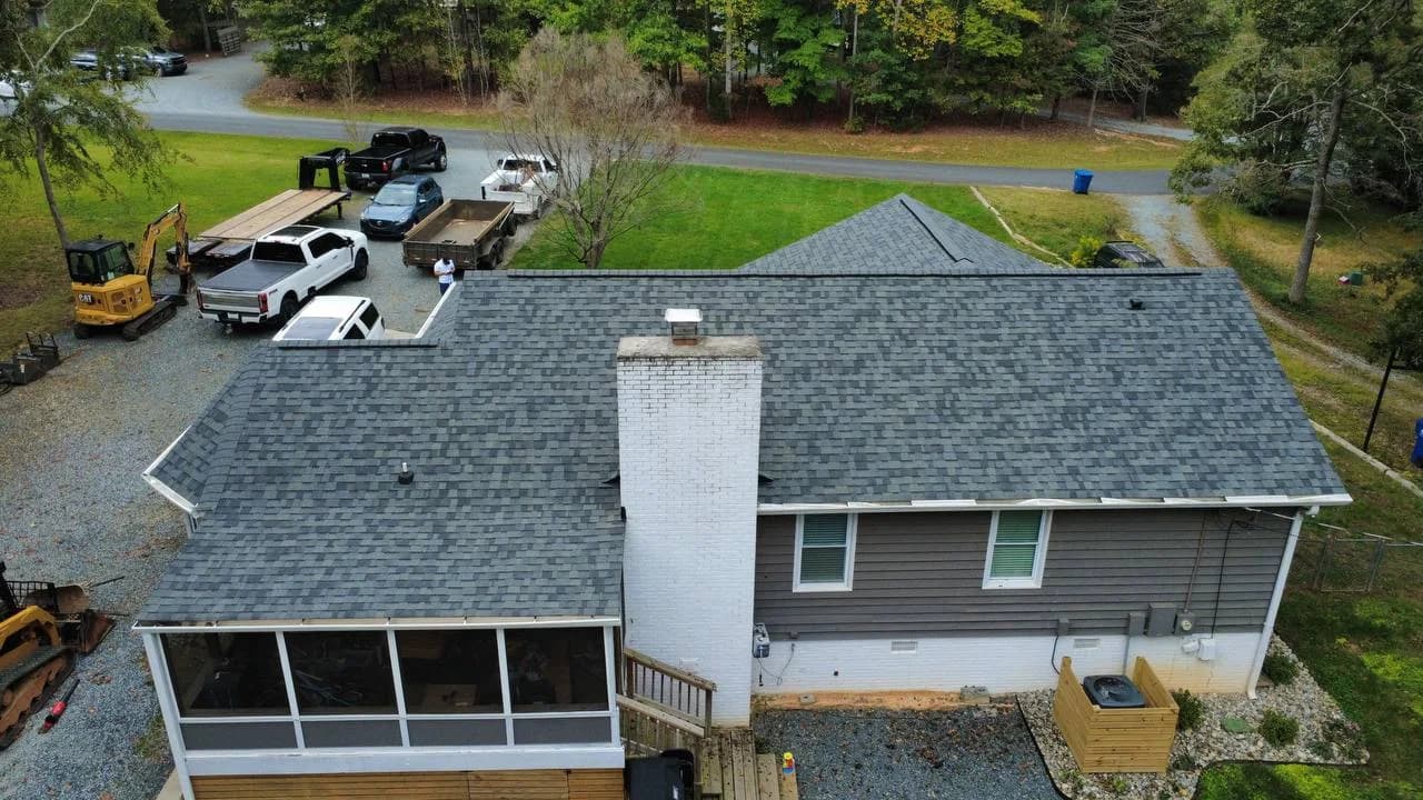 Overhead drone photo of completed asphalt shingle roofing system on a gray Carolina home