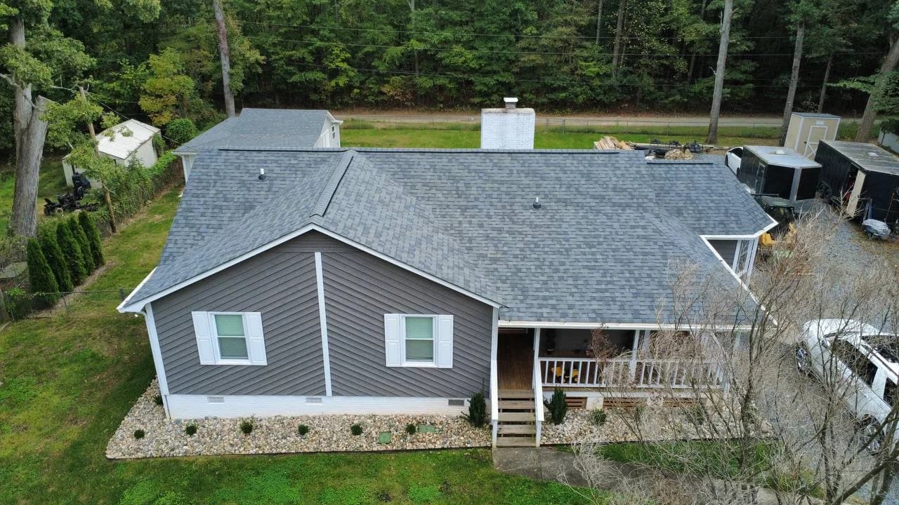 Street-side drone photo of gray architectural shingle roof installed by Kaliber Roofing