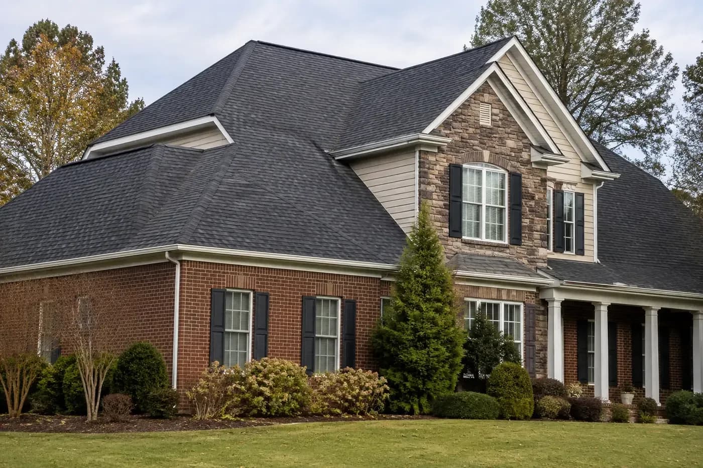 Roof-dominant Indian Trail NC home with coherent eaves, soffits, gutters, and ridge ventilation