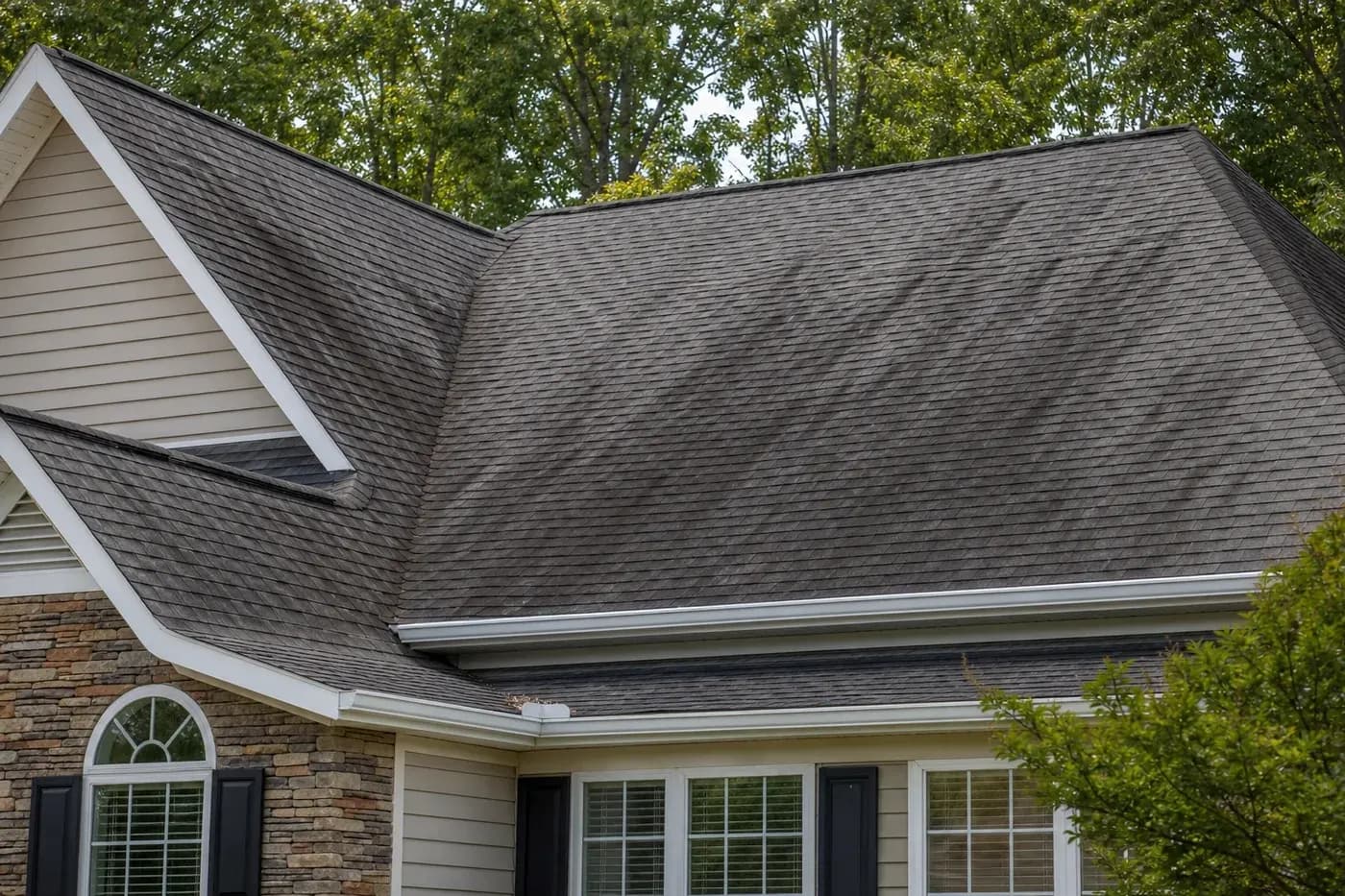 Charlotte NC asphalt shingle roof with dark algae streaks under mature trees