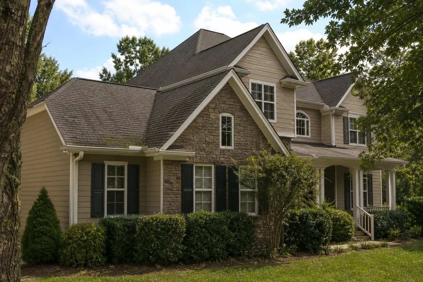Realistic Indian Trail NC home with an architectural asphalt shingle roof and subtle moss growth on a shaded roof slope