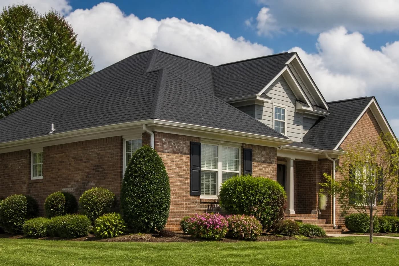 Roof-dominant upscale Indian Trail NC brick home with a newly completed charcoal architectural shingle roof