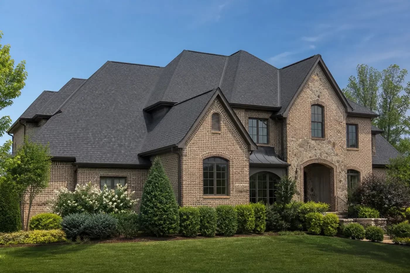 Roof-dominant upscale Indian Trail NC home with a coherent charcoal architectural shingle roof
