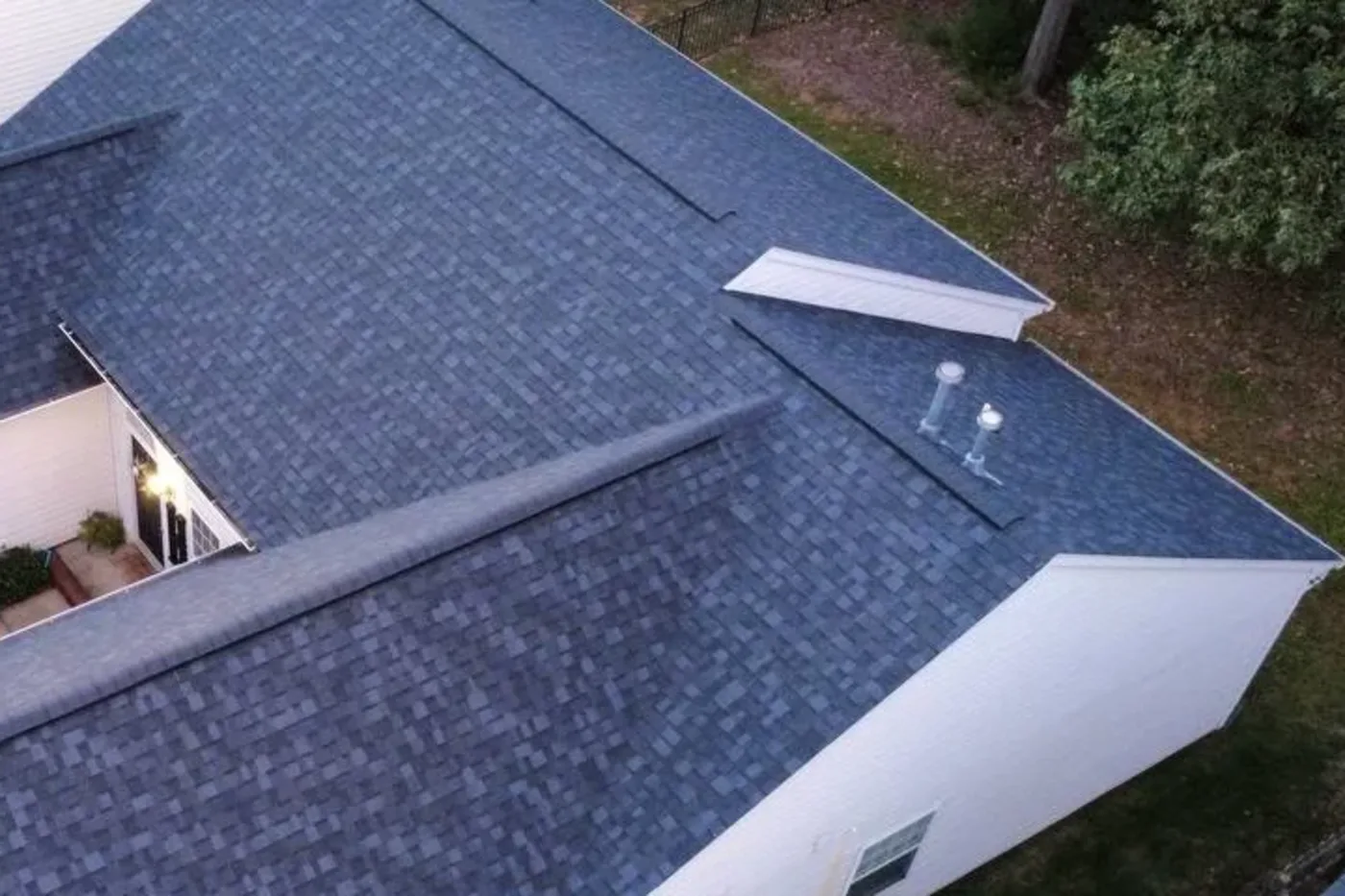 Indian Trail NC asphalt shingle roof near mature trees with overhanging branches close to the roofline