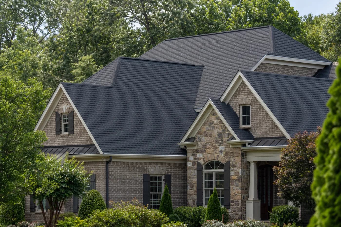 Roof-dominant upscale Indian Trail NC home surrounded by mature green landscaping