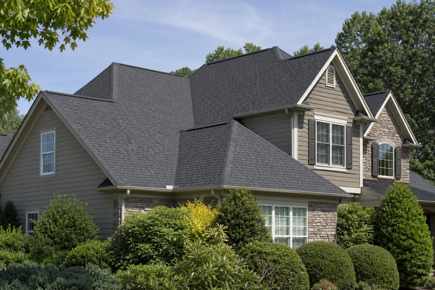 Roof-dominant upscale Indian Trail NC home with architectural shingles and a coherent vented roof system