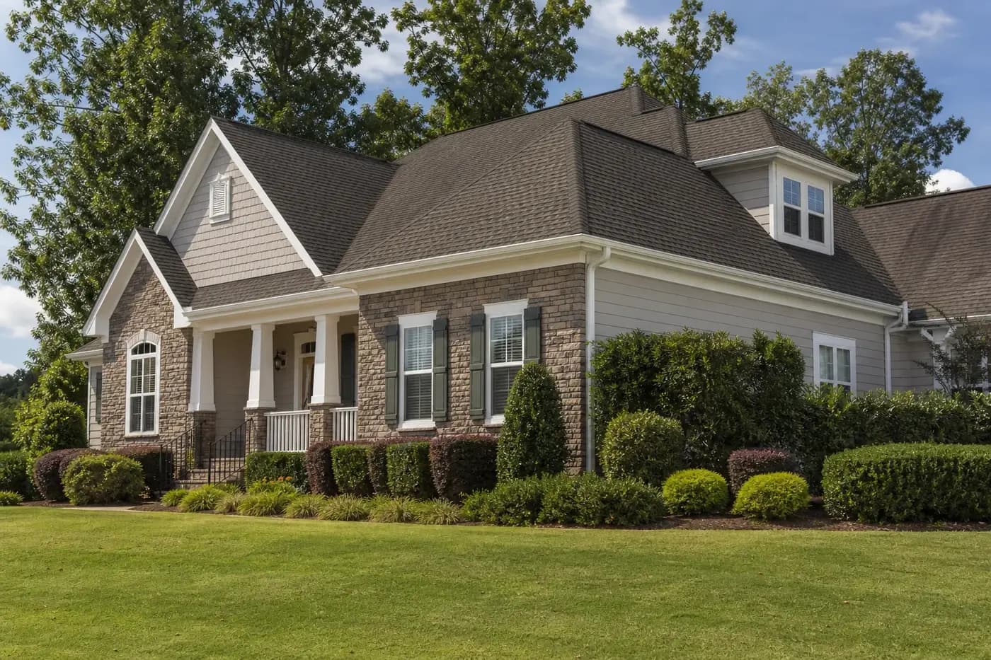 Upscale Indian Trail NC home with a clean architectural shingle roof and mature trees, with no people, animals, or vehicles visible