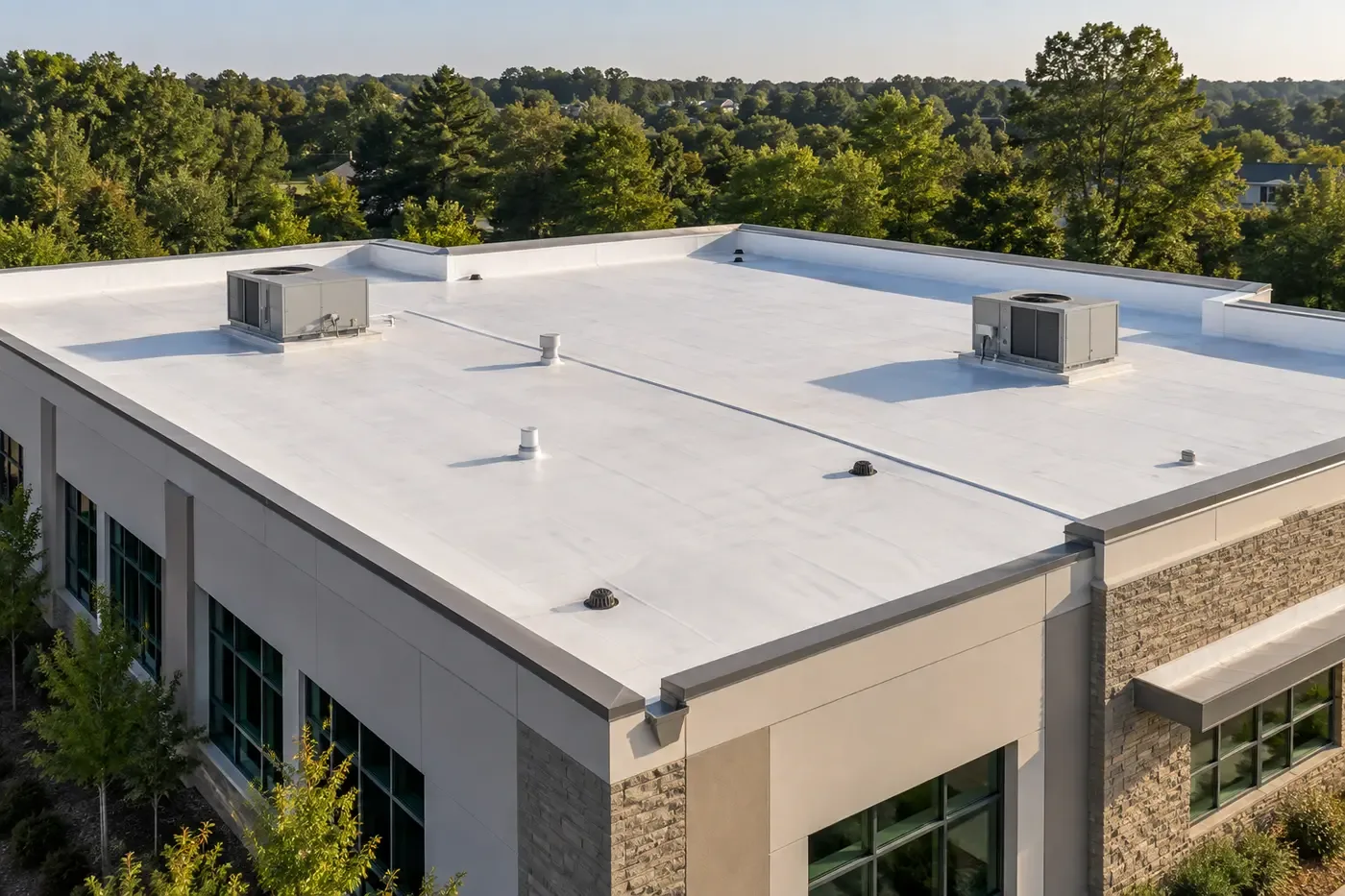 Representative Indian Trail commercial building with a clean white low-slope membrane roof, parapets, drains, and rooftop units