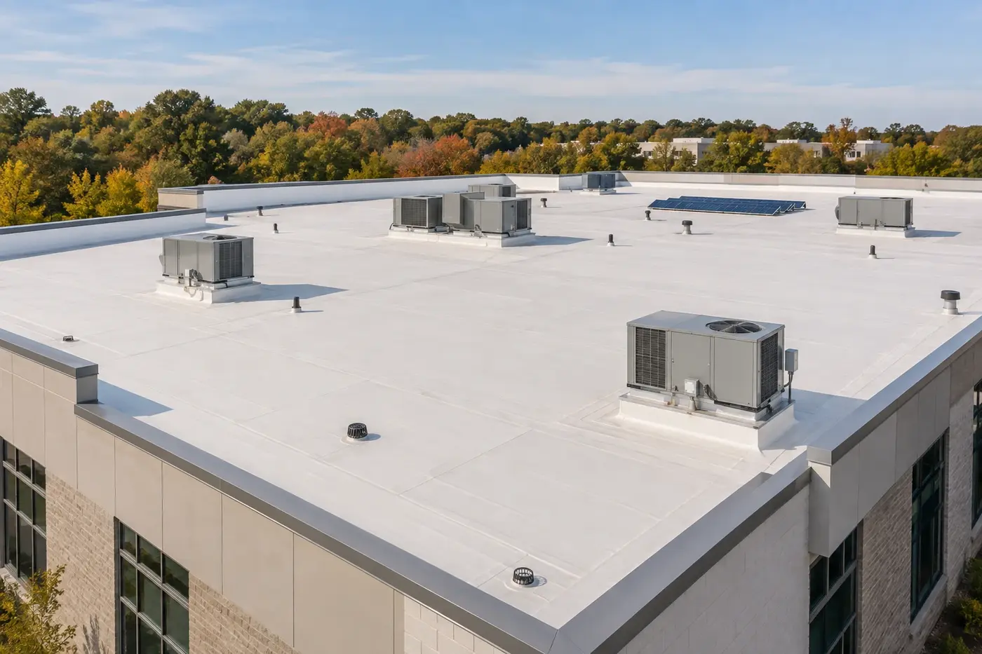 Representative Indian Trail commercial building with a clean low-slope membrane roof, rooftop equipment, drains, and a small solar array