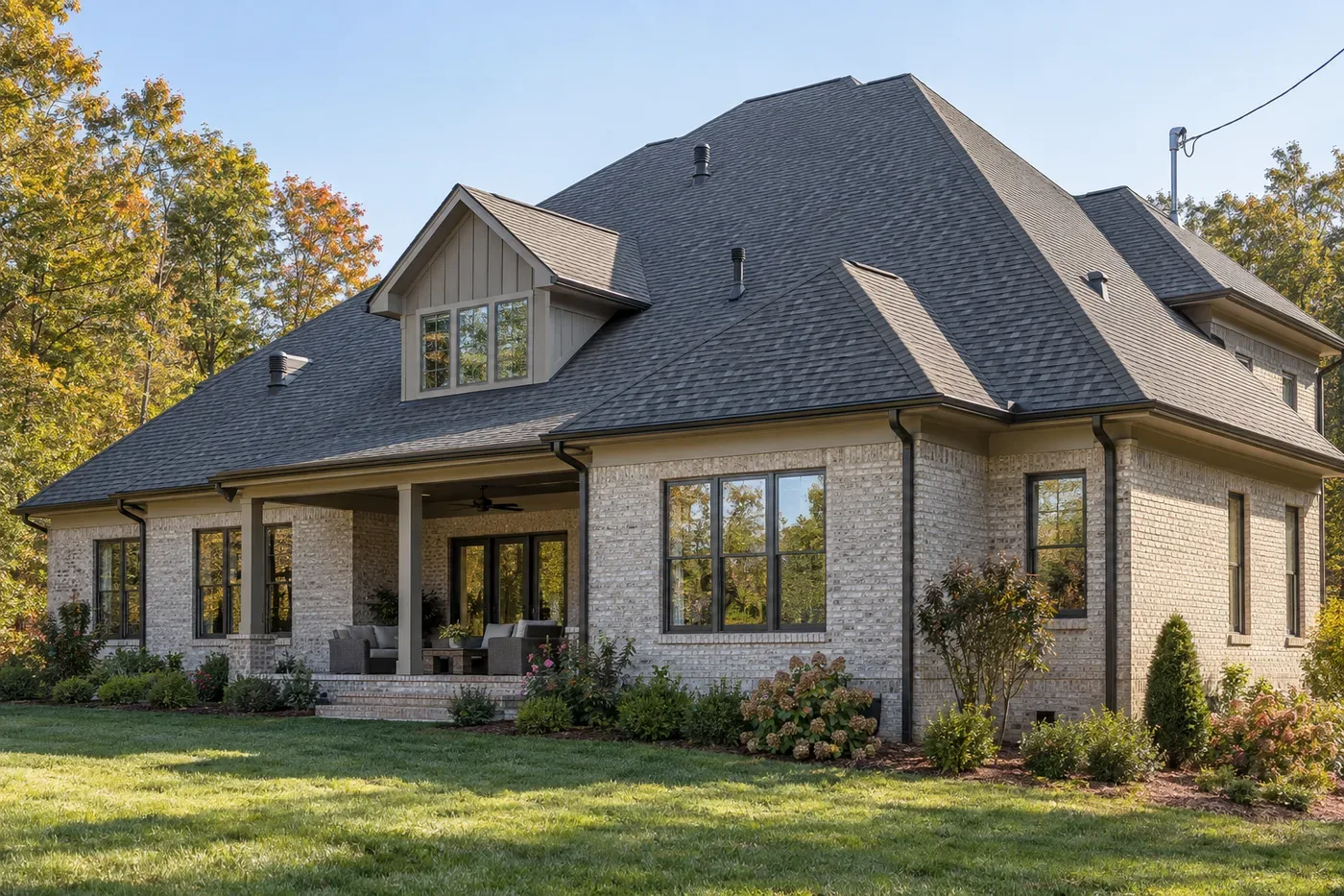 Representative upscale Indian Trail home with a prominent charcoal shingle roof and an electrical service mast