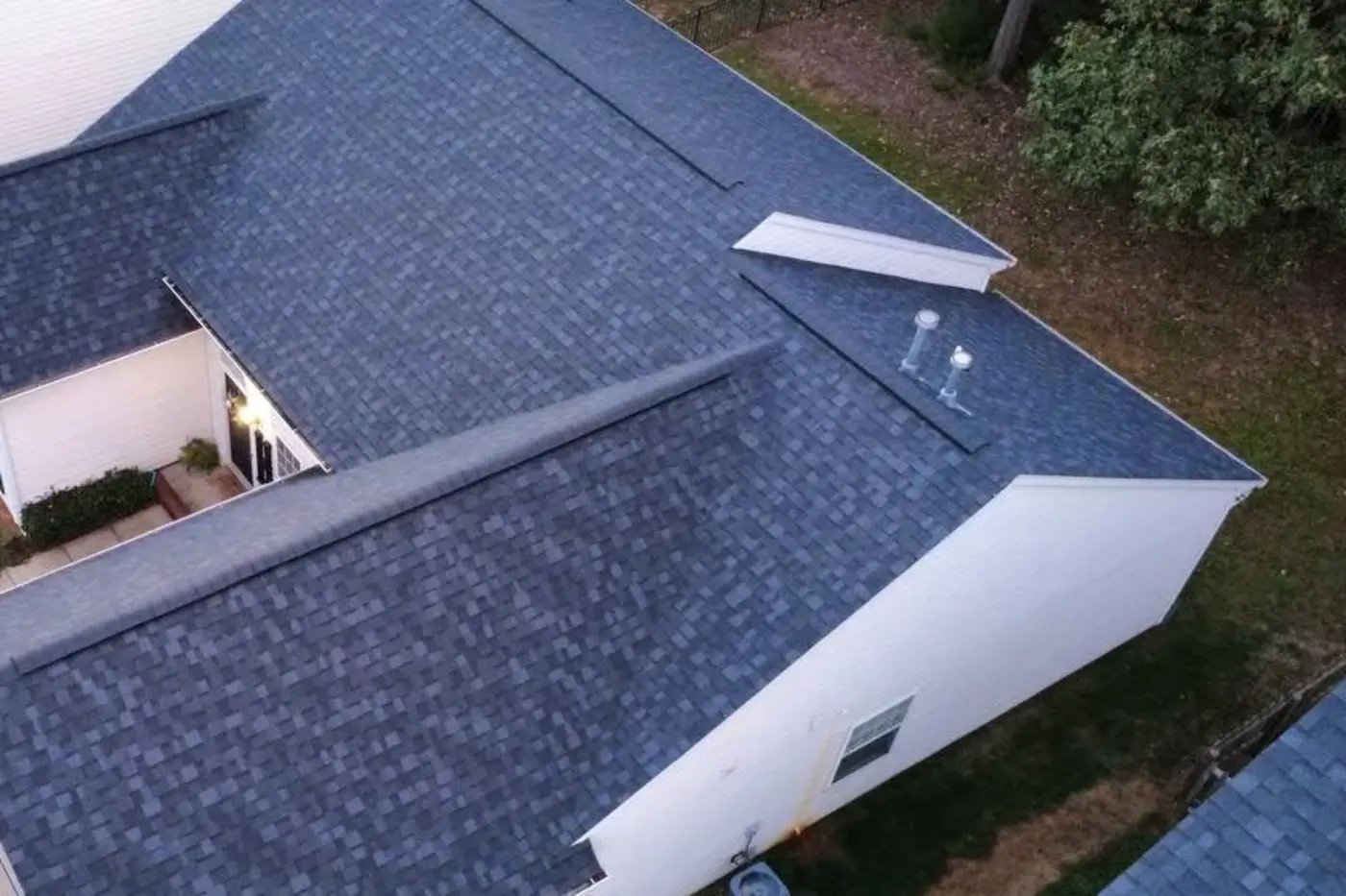 Aerial photo of a completed Kaliber architectural-shingle roof on a white home
