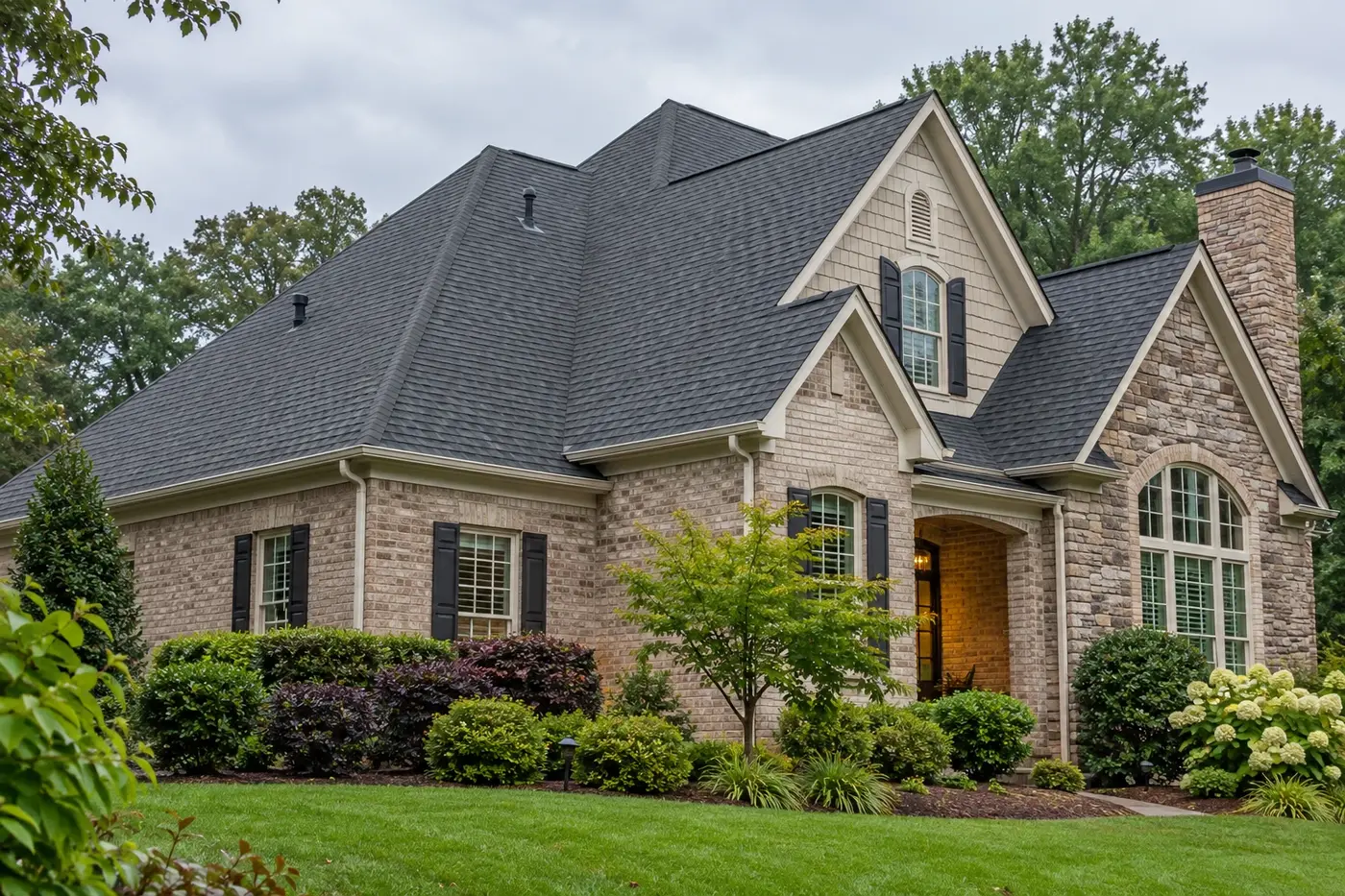 Representative upscale Indian Trail home with a prominent charcoal architectural-shingle roof after rain
