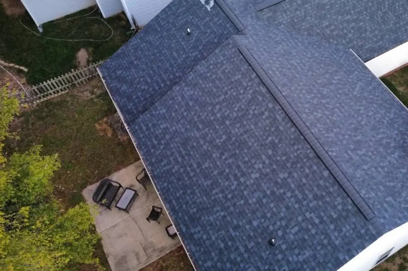Overhead photo of a completed Kaliber architectural-shingle roof showing several connected roof pitches and ridge lines