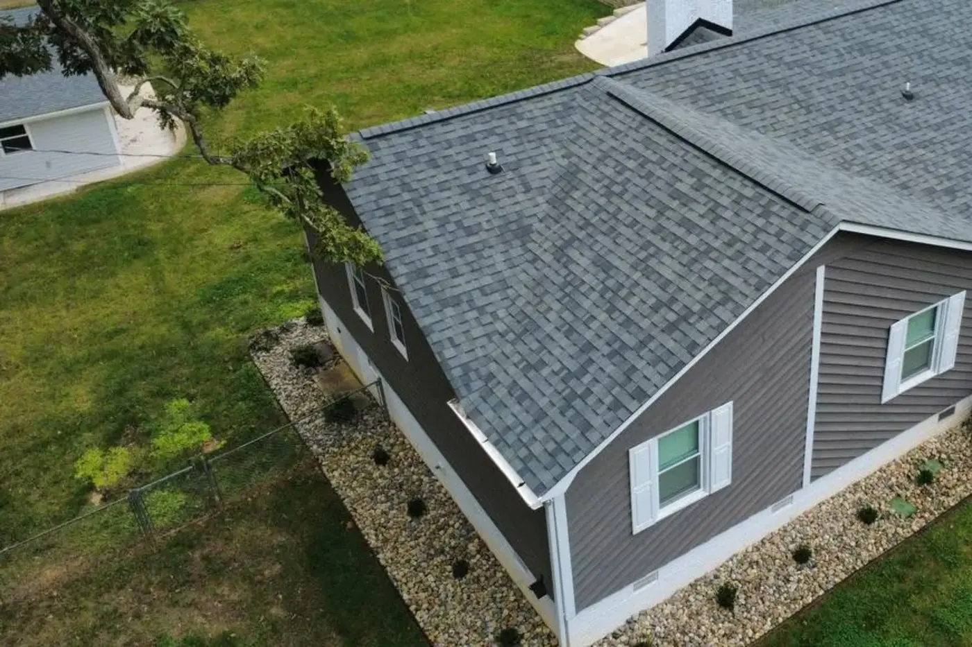 Aerial photo of a completed Kaliber gray architectural-shingle roof with visible ridge and roof vents