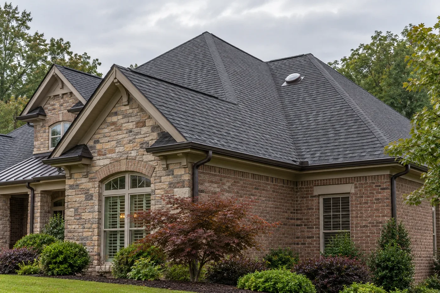 Representative Indian Trail home with a prominent charcoal shingle roof and one tubular skylight dome