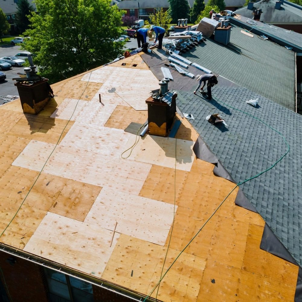 roof-repairs-old-roof-replacement-with-new-shingles-of-an-apartment-building.jpg